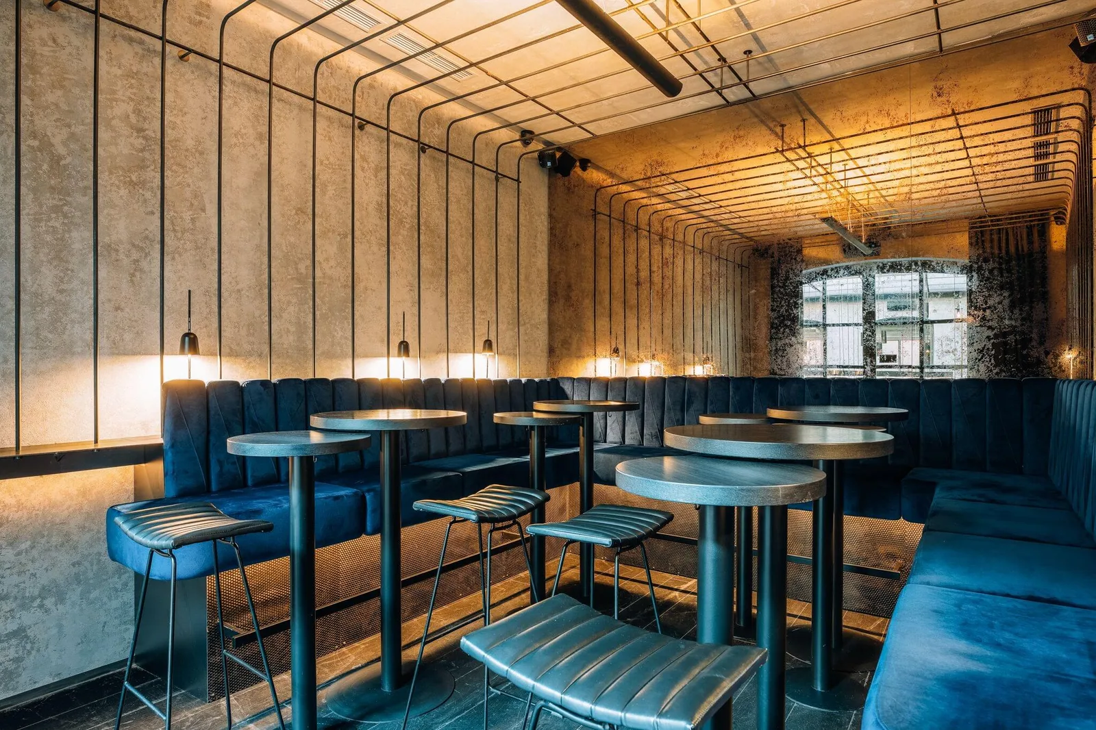 Lounge seating and high tables under a lit grid ceiling at MOON Club & Lounge, Dlouhá street, Old Town, Prague