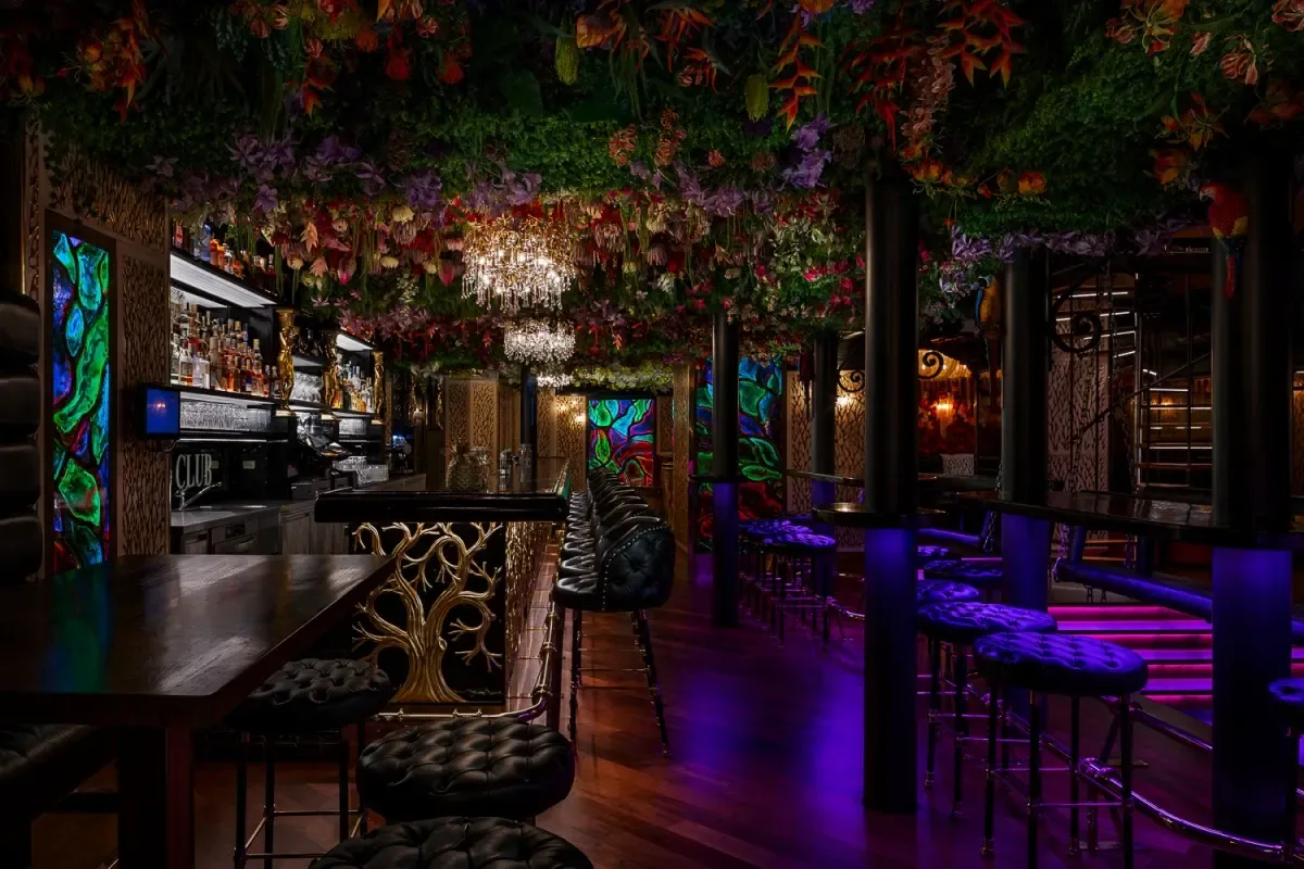 Main bar of The Roots nightclub at Zlatý Strom, with a flower-covered ceiling and booth seating, Karlova street, Prague