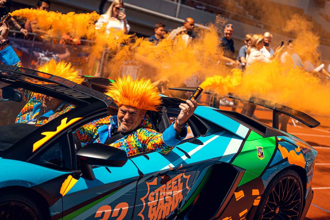 Lamborghini with orange smoke bomb at the start
